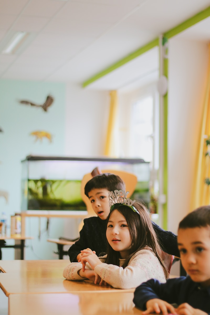 a group of children sitting at a table